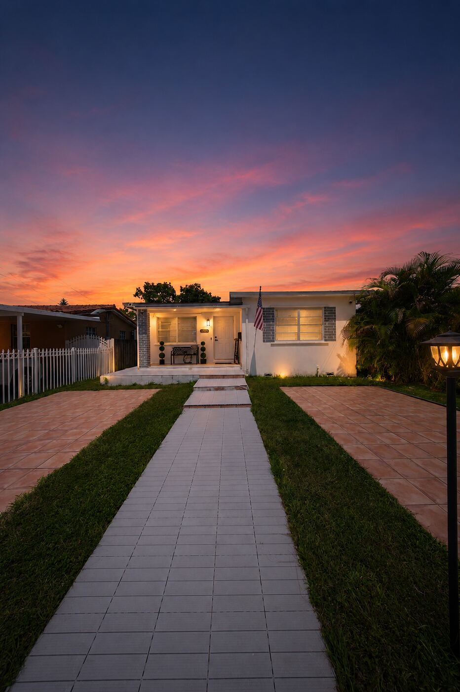 333 NW 60th Ave in Flagami at dusk, lit entry and paver driveway under a sunset sky